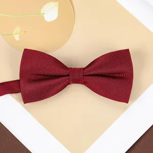 Wine red bow tie detail showing fine textured fabric, ideal for wedding and formal suit wear.
