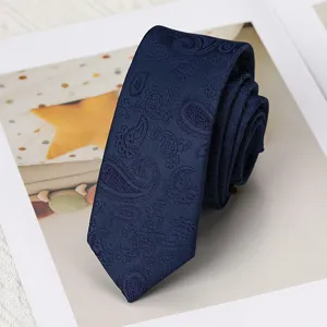 Primer plano de una corbata estrecha azul oscuro con cachemir y textura tejida.