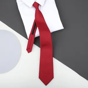 Close-up detail of smooth red zipper necktie displayed neatly on crisp white shirt and background.