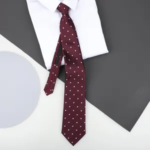 Burgundy polka dot zipper necktie detail shot, showing fabric texture and white shirt pairing.