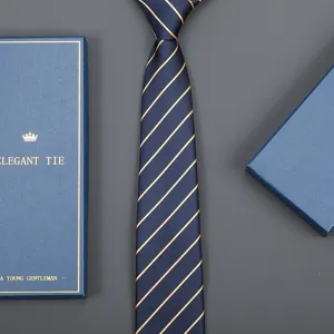 Detail shot of navy blue striped tie with gift box, elegant business accessory for men.