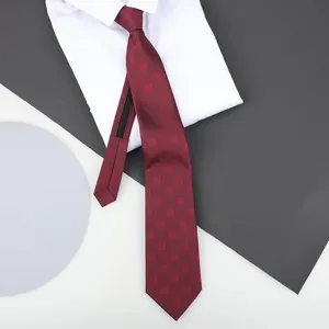 Red zipper tie with geometric square pattern displayed on a clean white shirt for formal wear.