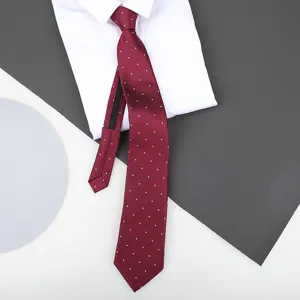 Detailed view of the red polka dot zipper tie showing fabric texture and structure.