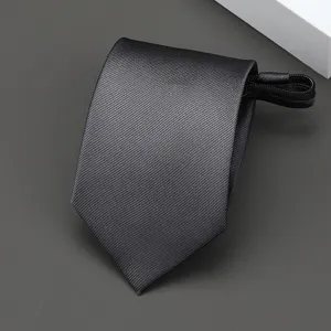 Detailed view of the dark grey zippered skinny necktie, showcasing fine diagonal twill texture.