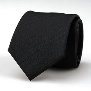 Detailed view of a classic black men's business necktie featuring fine textured diagonal weave.