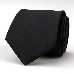 Detailed close-up shot of a stylish black fabric necktie featuring subtle geometric lines.