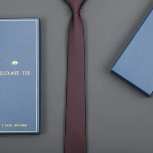Close-up detail of the maroon slim necktie paired with an elegant blue gift box packaging.