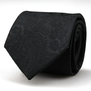 Close-up detail of a classic black necktie featuring an elegant woven paisley pattern for formal wear.