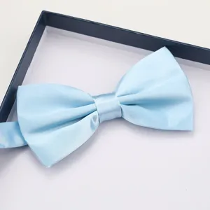Detail view of a light blue satin bow tie in gift box for wedding and formal suit