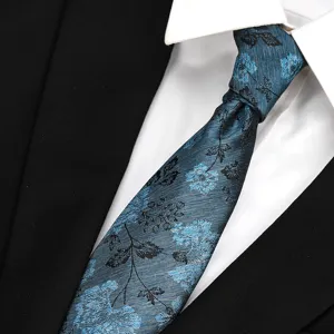 Detailed close-up view of the stylish blue floral necktie, showing fabric texture.