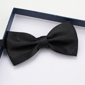 Detailed view of a classic black satin bow tie presented in a neat gift box for formal wear.