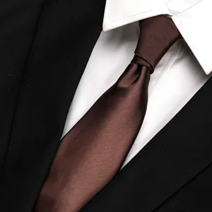 Classic brown silk tie paired with white shirt and black suit for formal business wear.