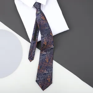 Close-up detail of a blue paisley patterned zipper necktie displayed on a crisp white shirt.
