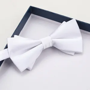 Detailed view of elegant white bow tie in luxury gift box, perfect for formal events.
