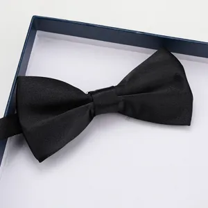 Classic black satin bow tie for men formal wear wedding suit detail close-up presentation.