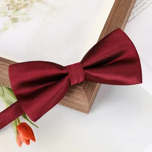 Burgundy solid color men's bow tie for wedding suit and formal business wear elegant accessory.