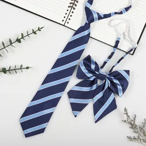 Detail view of Japanese JK DK style pre-tied striped necktie and bow tie set in navy blue.