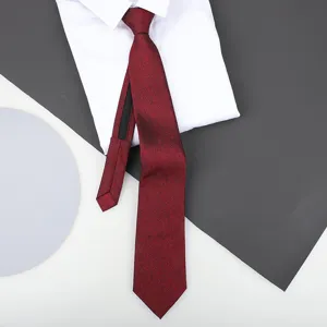 Red zipper tie detail close-up, showing fine textured fabric paired with a white dress shirt.
