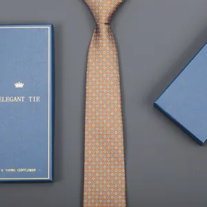 Brown patterned formal business tie with delicate geometric motifs, displayed with gift box detail.