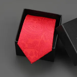 Detail view of a classic red paisley jacquard tie inside a premium black gift box.