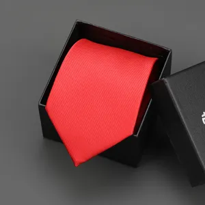 Red formal necktie neatly packed in a black gift box, ideal for business suits and weddings.