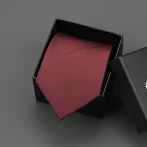 Burgundy necktie with black abstract lines in gift box, perfect for business formal wear.