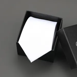 Close-up detail view of a white necktie neatly presented inside a black gift box.