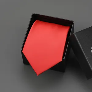 Detailed view of a classic red men's tie neatly folded inside a black gift box, elegant accessory.