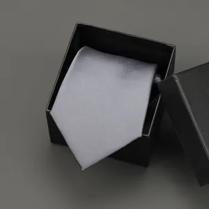 Detailed view of a sleek grey necktie neatly presented inside a classic black gift box.
