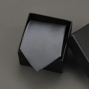 Detailed view of a classic grey business tie in a black gift box, perfect for formal suits and weddings.
