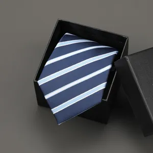 Detailed view of a classic blue striped necktie neatly folded inside a black gift box.