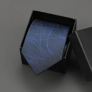 Detailed view of the blue patterned necktie neatly packed in an elegant black gift box.