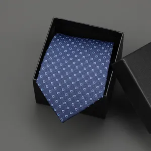 Blue patterned necktie detail view, elegant men business formal wear accessory in black gift box