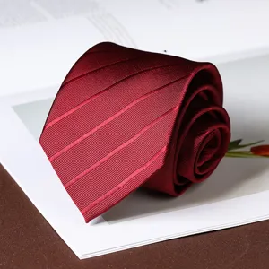 Close up detail view of wine red striped tie fabric texture, elegant rolled necktie design