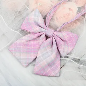 Pink and grey plaid JK uniform bow tie detail closeup, sweet sailor collar ribbon accessory.