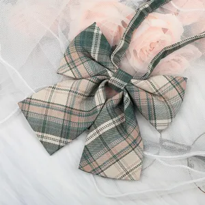 Detailed close-up of a Japanese JK style green and beige plaid bow tie with ribbons.