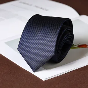 Detail shot of a classic dark blue striped necktie rolled neatly on a stylish background.