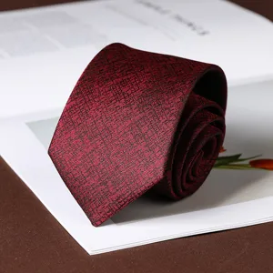 Close-up of a dark red textured necktie, stylish grid pattern fabric for business formal wear.
