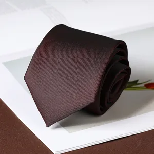 Dark red striped necktie detail shot, rolled up neatly on clean white paper background.