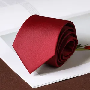 Close-up of wine red business formal tie, displaying fine fabric texture and elegant roll design.