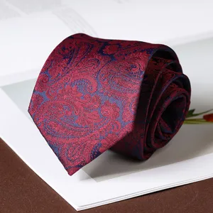 Red paisley necktie detail shot, classic men business formal wear tie with exquisite pattern.