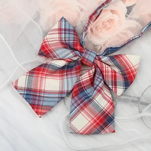 Close-up detail of Japanese JK style red and blue plaid bow tie ribbon collar accessory.
