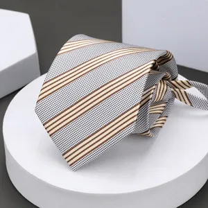 Men's business striped tie detail view, classic grey and brown pattern for professional wear.
