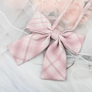 Detailed close-up shot of a pink plaid JK bow tie collar accessory with elegant ribbons.