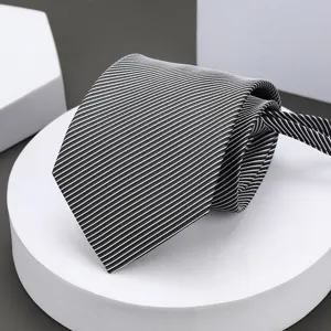 Close-up view of the classic black and white striped business tie texture and neat fold detail.