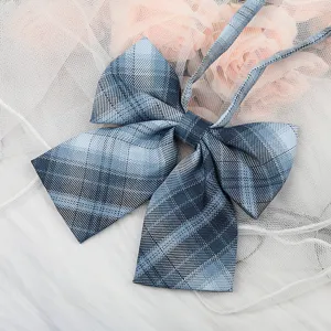 Close-up detail of a Japanese JK style blue plaid bow tie ribbon collar accessory for shirts.