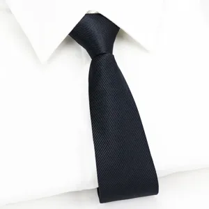 Close-up detail of classic black men business suit tie with diagonal weave texture.