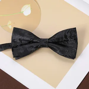 Close-up detail of a classic black jacquard bow tie, premium woven fabric, perfect for formal suits.