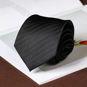 Detail view of a stylish black pleated men necktie, perfect for formal business and wedding events.