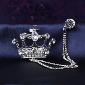 Close-up view of silver crown brooch with crystal chain detail for men suit collar decoration.